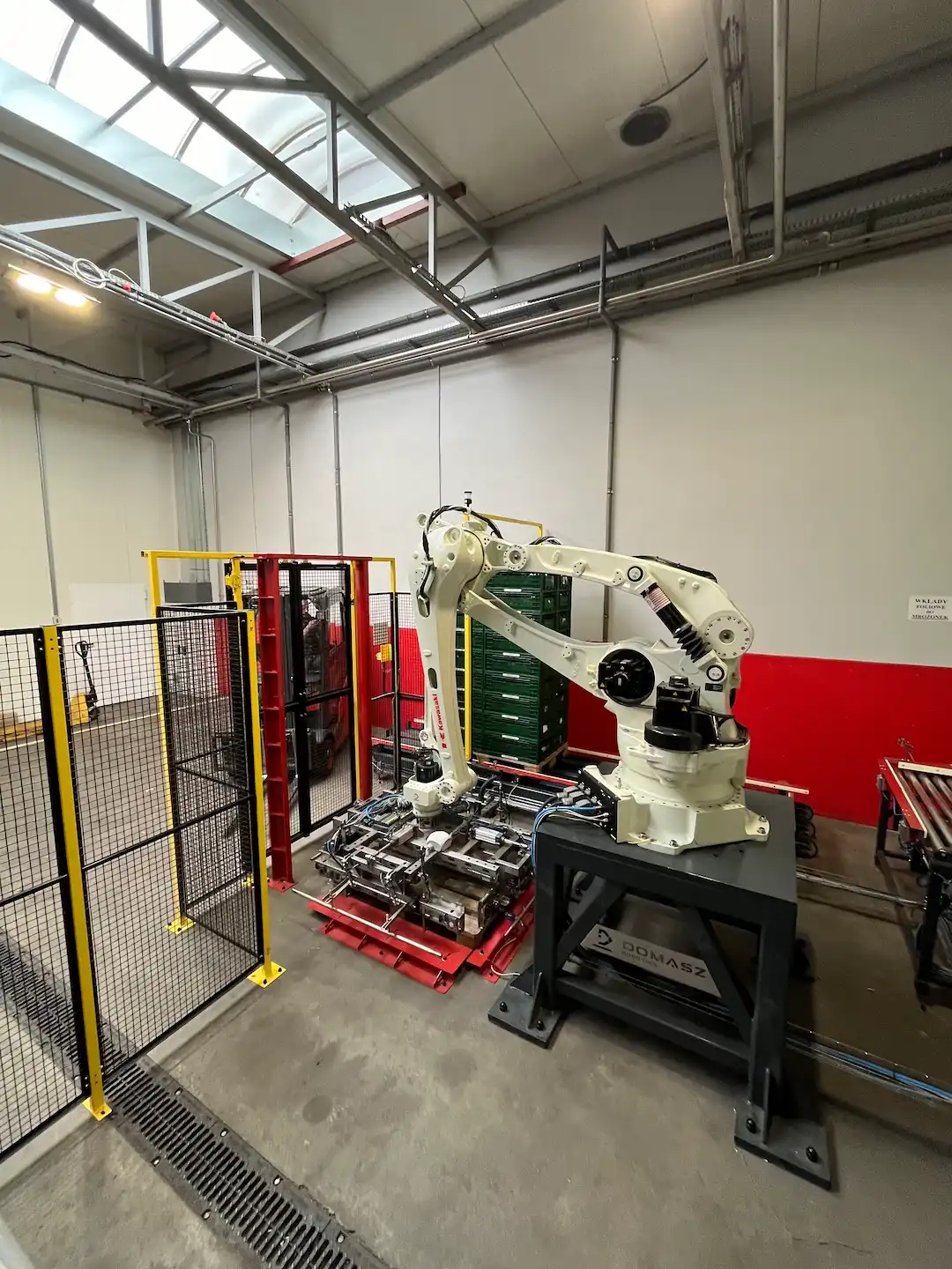 Stanowisko robota układającego skrzynki z cebulą.